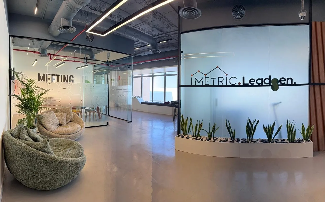 The iMetric office — meeting rooms and lounge with the iMetric logo wall